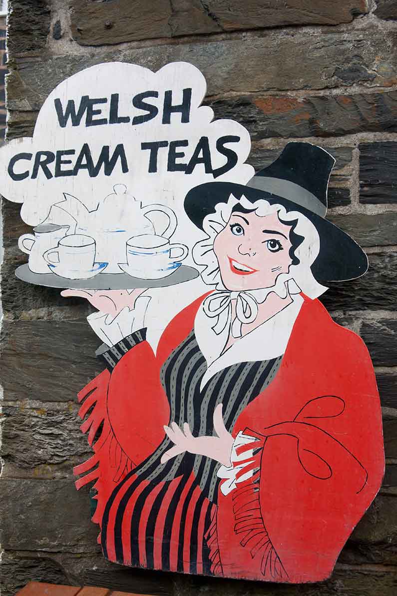Image of Welsh woman in traditional costume advertising Welsh cream teas
